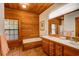 Bathroom with double vanity, large mirror, and a soaking tub at 1785 Whitley Rd, Dacula, GA 30019