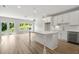 Open concept kitchen with island, white cabinets and stainless steel appliances at 1321 Parc Bench Rd, Atlanta, GA 30316
