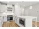 Modern kitchen with white cabinets, island, and stainless steel microwave at 1321 Parc Bench Rd, Atlanta, GA 30316