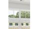 Bedroom with large window overlooking treetops and neighboring buildings at 1321 Parc Bench Rd, Atlanta, GA 30316