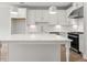 Modern kitchen island with white cabinets and quartz countertop at 1321 Parc Bench Rd, Atlanta, GA 30316