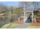 White footbridge over a calm pond in a serene park-like setting at 4571 Columns Se Dr, Marietta, GA 30067