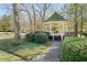 Quaint gazebo with a mossy roof, surrounded by lush greenery at 4571 Columns Se Dr, Marietta, GA 30067