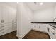 Bright laundry room with white cabinets and dark hardwood floors at 4571 Columns Se Dr, Marietta, GA 30067