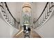 Impressive entry with double staircase and crystal chandelier at 4571 Columns Se Dr, Marietta, GA 30067