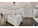 Open concept kitchen with island, white cabinets, and hardwood floors at 4571 Columns Se Dr, Marietta, GA 30067