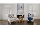 Cozy sitting area with fireplace and comfortable armchairs at 4571 Columns Se Dr, Marietta, GA 30067