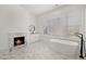 Modern bathroom with marble floors, fireplace, and soaking tub at 4571 Columns Se Dr, Marietta, GA 30067