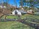 White barn with covered stalls and fencing at 4571 Columns Se Dr, Marietta, GA 30067