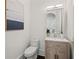 Modern powder room featuring a light oak vanity and a white toilet at 4571 Columns Se Dr, Marietta, GA 30067