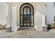 Front entrance with arched black door and stone flooring at 4571 Columns Se Dr, Marietta, GA 30067