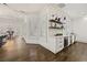 Stylish kitchen featuring white cabinets, a wine cooler, and marble countertops at 4571 Columns Se Dr, Marietta, GA 30067