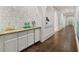 Wet bar with hexagon marble tile and brass countertop at 4571 Columns Se Dr, Marietta, GA 30067