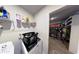 Laundry room with washer, dryer, shelving, and walk-in closet at 163 Kingfisher Walk, Covington, GA 30014