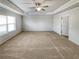 Large bedroom with carpeted floor and tray ceiling at 4449 Sierra Creek Dr, Hoschton, GA 30548