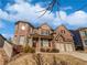 Brick two-story house with a three-car garage and manicured lawn at 4449 Sierra Creek Dr, Hoschton, GA 30548