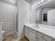 Bathroom with white vanity, large mirror, and tile flooring at 12265 Cypress Way, Fayetteville, GA 30215