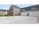 Two story home with attached three car garage and concrete driveway at 600 Silver Moon Dr # 08, Loganville, GA 30052