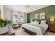 Bright main bedroom with green accent wall and ample natural light at 600 Silver Moon Dr # 08, Loganville, GA 30052