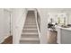 Carpeted stairs with metal railing leading to the upper level at 600 Silver Moon Dr # 08, Loganville, GA 30052