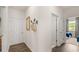 Bright hallway with white walls, wood floors, and access to bedrooms at 600 Silver Moon Dr # 08, Loganville, GA 30052