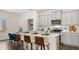 Modern kitchen with white cabinets, quartz countertops, and island seating at 600 Silver Moon Dr # 08, Loganville, GA 30052