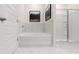 Relaxing bathroom with soaking tub, walk-in shower, and marble tile at 600 Silver Moon Dr # 08, Loganville, GA 30052