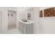 Bathroom with double vanity, marble tile, and linen closet at 600 Silver Moon Dr # 08, Loganville, GA 30052