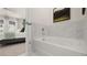 Bathroom with soaking tub, marble tile, and view to bedroom at 600 Silver Moon Dr # 08, Loganville, GA 30052