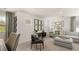 Open living room with sectional sofa, multiple windows, and a large art piece at 600 Silver Moon Dr # 08, Loganville, GA 30052