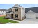 Two-story home with gray and brown brick exterior, attached garage, and landscaping at 600 Silver Moon Dr # 08, Loganville, GA 30052