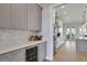 Modern kitchen features gray cabinets, marble backsplash, and wine cooler at 2334 Paces Ferry Se Rd, Smyrna, GA 30080