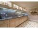 Basement wet bar with granite countertop and built-in cabinetry at 5326 Presley Pl, Douglasville, GA 30135