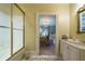Bathroom with shower, vanity, and view into a bedroom at 5326 Presley Pl, Douglasville, GA 30135