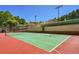 Green tennis court with red surface and basketball lines at 5326 Presley Pl, Douglasville, GA 30135
