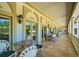 Covered balcony with French doors, tile flooring, and outdoor furniture at 5326 Presley Pl, Douglasville, GA 30135