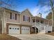 Tan house with stone accents, two-car garage, and porch at 47 Makayla Way, Temple, GA 30179