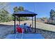 Cozy backyard patio with gazebo, table, and chairs at 6121 Sparkling Cove Ln, Buford, GA 30518