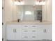 Double vanity bathroom with granite countertops and modern light fixtures at 987 Kora Sw Dr, Marietta, GA 30064