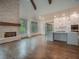 Living area with hardwood floors, stone fireplace, and kitchen view at 987 Kora Sw Dr, Marietta, GA 30064