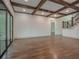 Spacious living room featuring hardwood floors, exposed wooden beams, and a view of the staircase at 987 Kora Sw Dr, Marietta, GA 30064