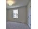 Well-lit bedroom with neutral wall colors and carpet flooring at 330 Cavin Dr, Roswell, GA 30076