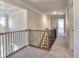 Upstairs hallway with wood railing and neutral carpeting at 330 Cavin Dr, Roswell, GA 30076