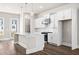 Open concept kitchen with white cabinets, island, and stainless steel appliances at 1952 Stanfield Nw Ave, Atlanta, GA 30318