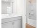 Bright bathroom with white vanity, tub shower combo, and wood-look flooring at 428 10Th St, Auburn, GA 30011