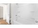 Simple bathroom with a tub and shower, toilet, and wood-look flooring at 428 10Th St, Auburn, GA 30011