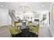 Bright dining room with glass table and modern chandelier at 428 10Th St, Auburn, GA 30011