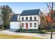 Two story home with a red door and attached garage at 428 10Th St, Auburn, GA 30011