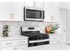 Modern kitchen with stainless steel appliances and white cabinets at 428 10Th St, Auburn, GA 30011