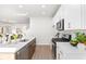 Modern kitchen with white cabinets, quartz countertops, and stainless steel appliances at 428 10Th St, Auburn, GA 30011